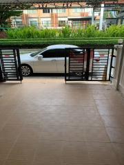 Building entrance view featuring gated car park and street-facing aspect