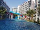 Modern residential complex with large swimming pool and water slide