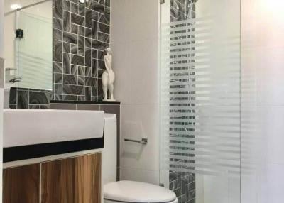 Modern bathroom with stylish tiles and glass shower