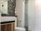 Modern bathroom with stylish tiles and glass shower