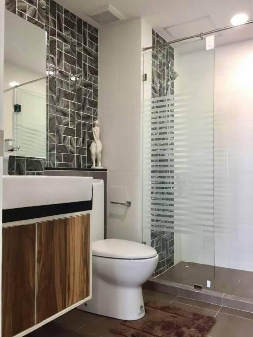 Modern bathroom with stylish tiles and glass shower