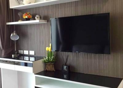 Modern living room interior with mounted television and decorative shelving