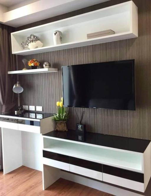 Modern living room interior with mounted television and decorative shelving