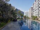 Modern apartment complex with residents enjoying amenities near a communal pool