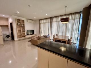 Spacious apartment interior with combined living and dining area, modern kitchen, and ample natural light