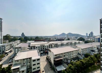 Expansive view from a high-rise apartment balcony showcasing the cityscape