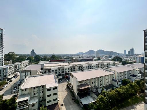 Expansive view from a high-rise apartment balcony showcasing the cityscape