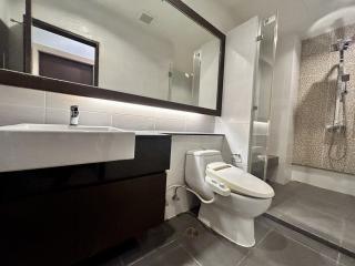 Modern bathroom with walk-in shower and large mirror