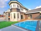 Modern two-storey house with a swimming pool and landscaped lawn