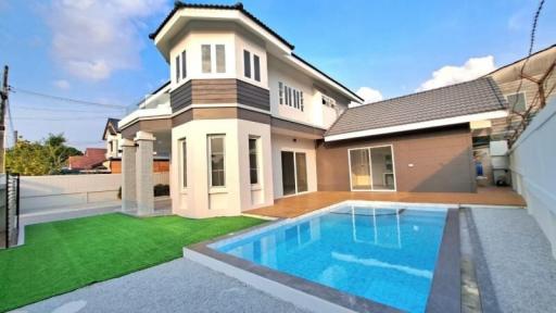 Modern two-storey house with a swimming pool and landscaped lawn