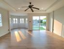 Spacious living room with abundant natural light and modern flooring