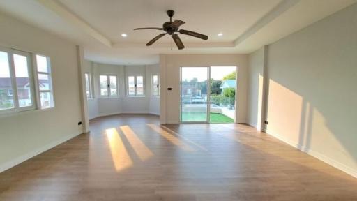 Spacious living room with abundant natural light and modern flooring