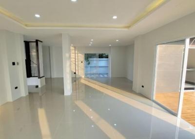 Spacious and bright living room with glossy tiled flooring and ample natural light
