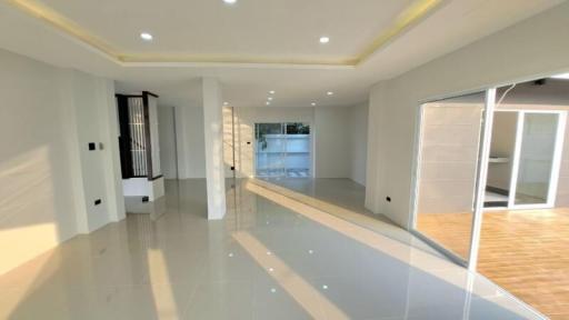 Spacious and bright living room with glossy tiled flooring and ample natural light