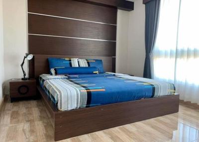 Modern bedroom with large bed and wooden floor