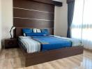Modern bedroom with large bed and wooden floor