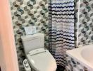 Modern bathroom with geometric tile pattern and bidet toilet