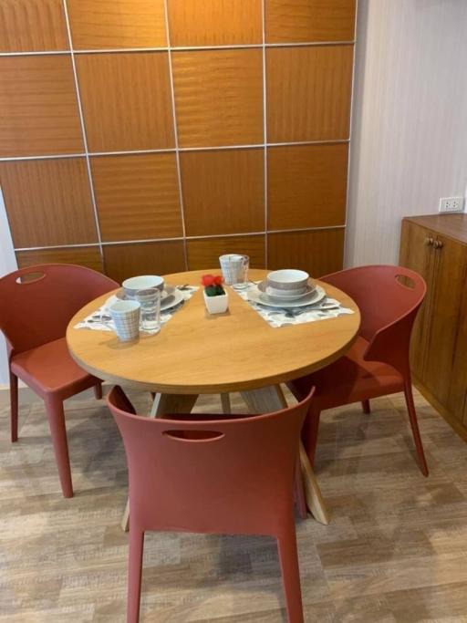 Cozy dining area with wooden table and red chairs