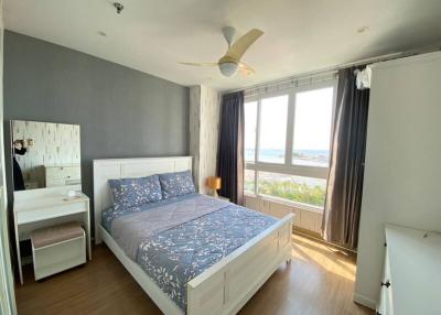 Well-lit bedroom with ocean view, double bed, and modern design