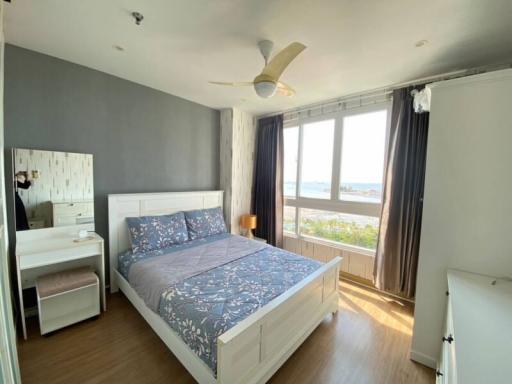 Well-lit bedroom with ocean view, double bed, and modern design