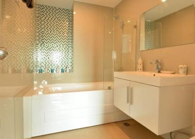 Modern bathroom with glass shower and white vanity