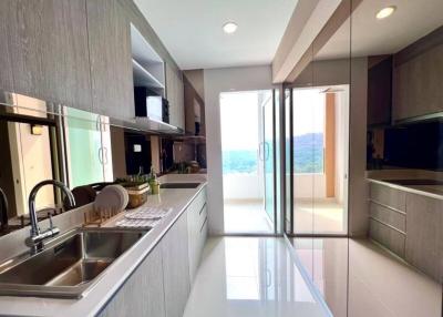 Modern kitchen with stainless steel appliances and a scenic view
