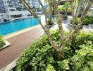 Lush greenery surrounding a communal swimming pool in a residential complex