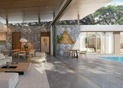 Luxurious open-plan living space with natural stone walls, elegantly designed interior, and seamless pool access