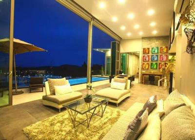 Spacious and modern living room with large windows and pool view
