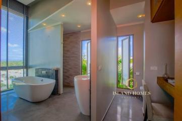 Modern bathroom with freestanding tub and large windows