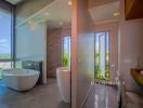 Modern bathroom with freestanding tub and large windows
