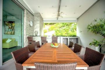Spacious dining area with large wooden table and modern chairs