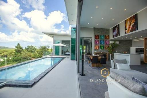 Spacious living area with open layout connecting to a swimming pool and offering a panoramic view