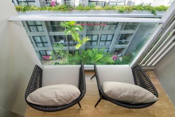 Cozy balcony with two chairs overlooking the courtyard garden