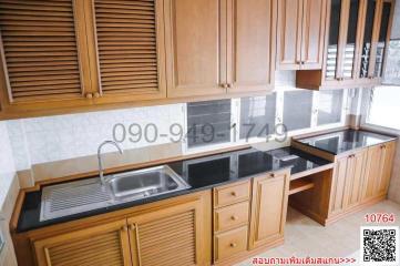 Spacious kitchen with wooden cabinets and modern appliances