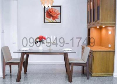 Elegant dining room interior with wooden furniture and decorative light fixture