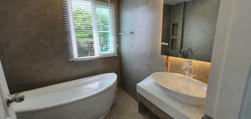 Modern bathroom with twin sinks and a bathtub