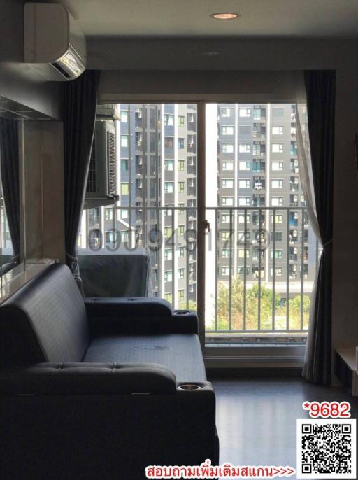 Spacious living room with modern furniture and balcony view