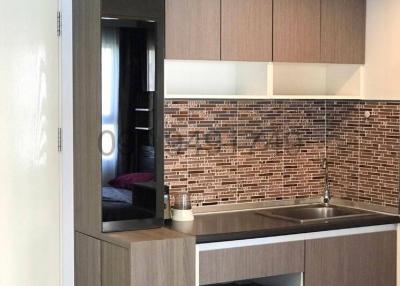 Modern kitchen with stainless steel appliances and brown brick backsplash