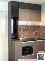 Modern kitchen with stainless steel appliances and brown brick backsplash