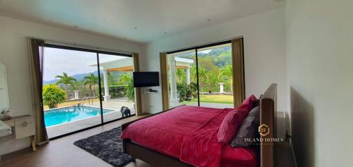 Spacious Bedroom with Pool View and Ample Natural Light