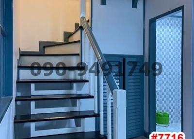 Modern staircase with metal railing in a well-lit space