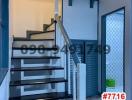 Modern staircase with metal railing in a well-lit space