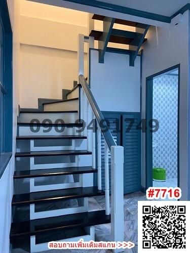 Modern staircase with metal railing in a well-lit space