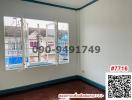 Empty bedroom with natural light and a view of neighboring buildings