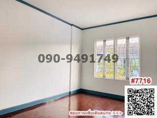 Spacious unfurnished bedroom with large window and hardwood floors