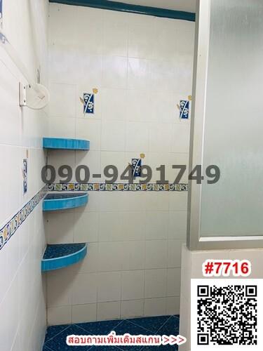 Modern bathroom interior with built-in shelves and patterned tiles