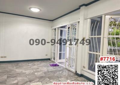 Empty room with tiled floor and large windows