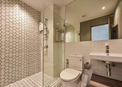 Modern bathroom with walk-in shower and hexagonal tiles