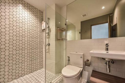 Modern bathroom with walk-in shower and hexagonal tiles